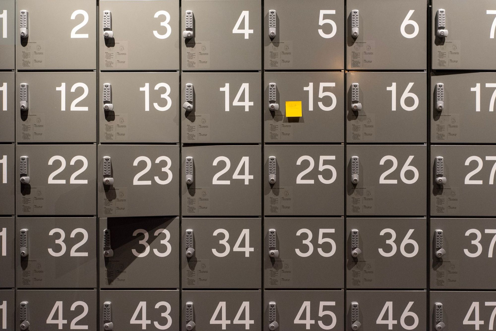 Wall of identical numbered lockers with electronic locks